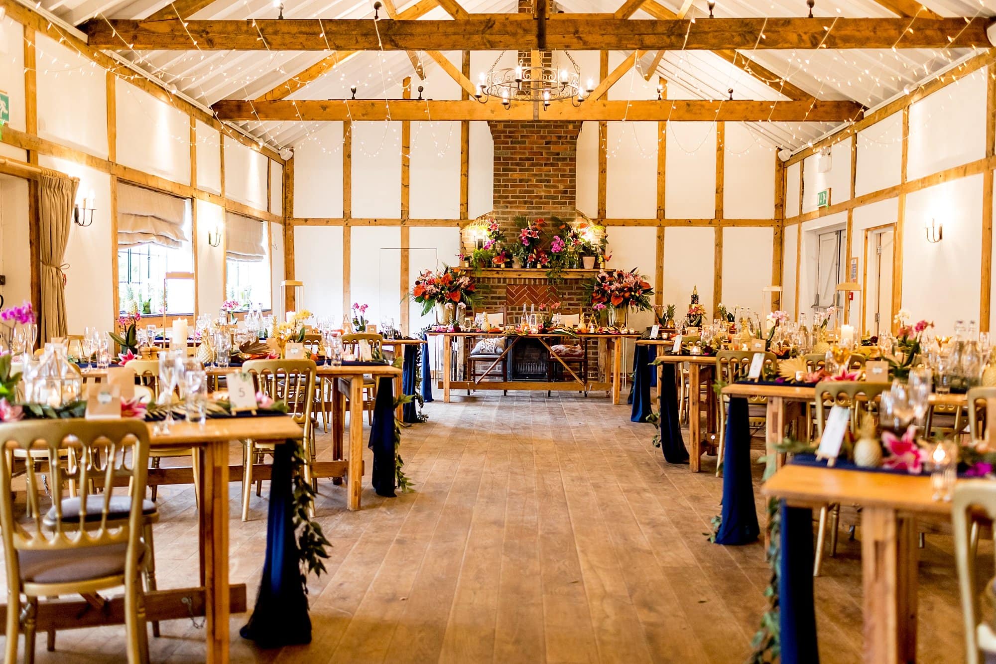 burley manor wooden beam hall colourful tropical wedding styling