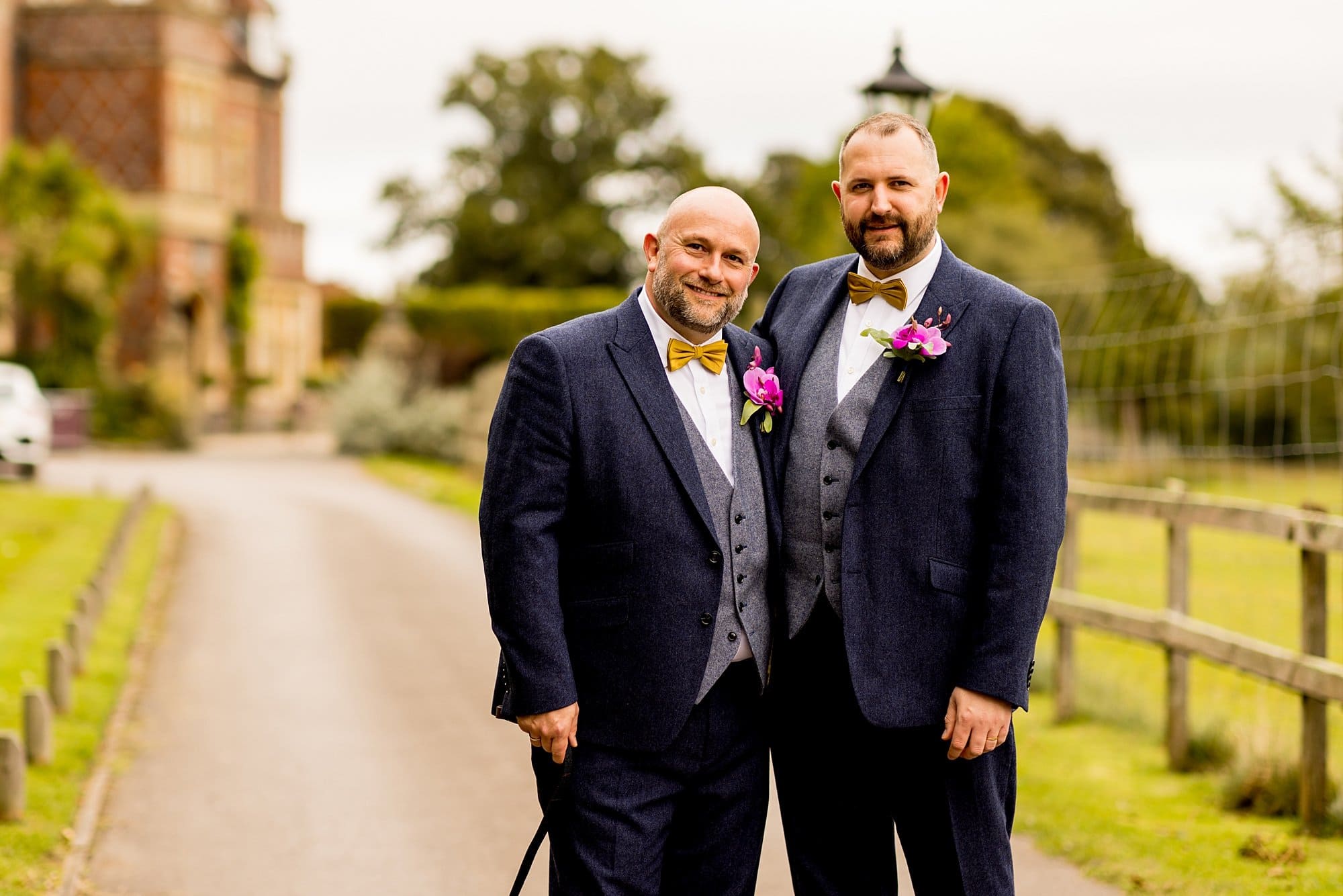 burley manor lgbtq wedding navy tweed suit gret waistcoat mustard yellow bow tie