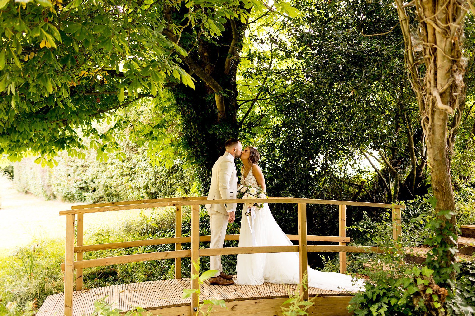 chic styled wedding southend barns bride groom portrait tree lined bridge