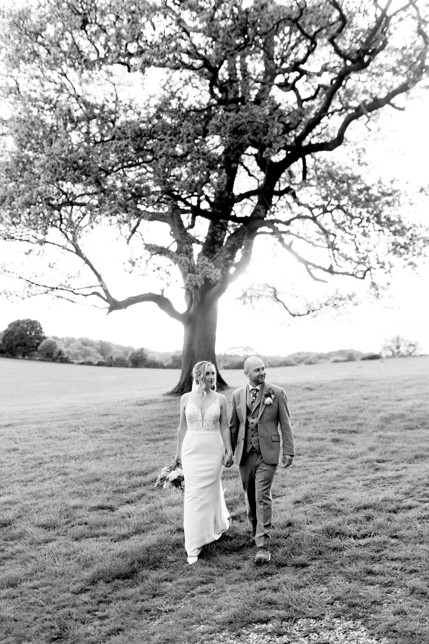 candid photograph of bride and groom walking