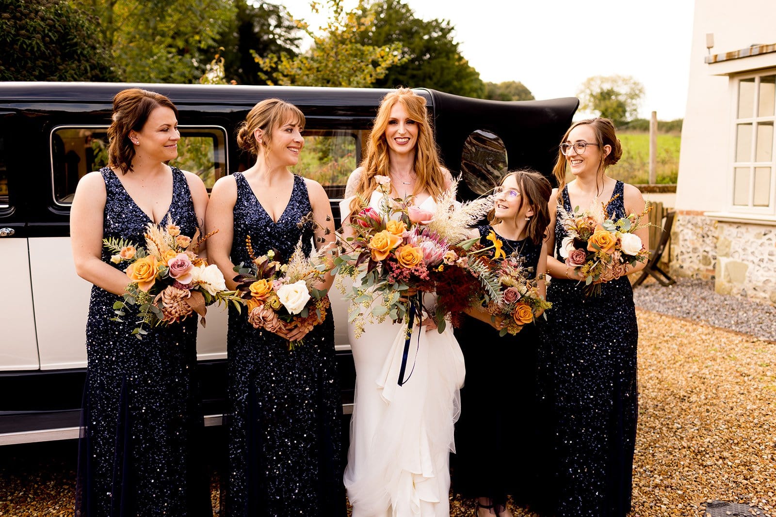 Bridesmaid photo wearing navy glittery bridesmaid dresses
