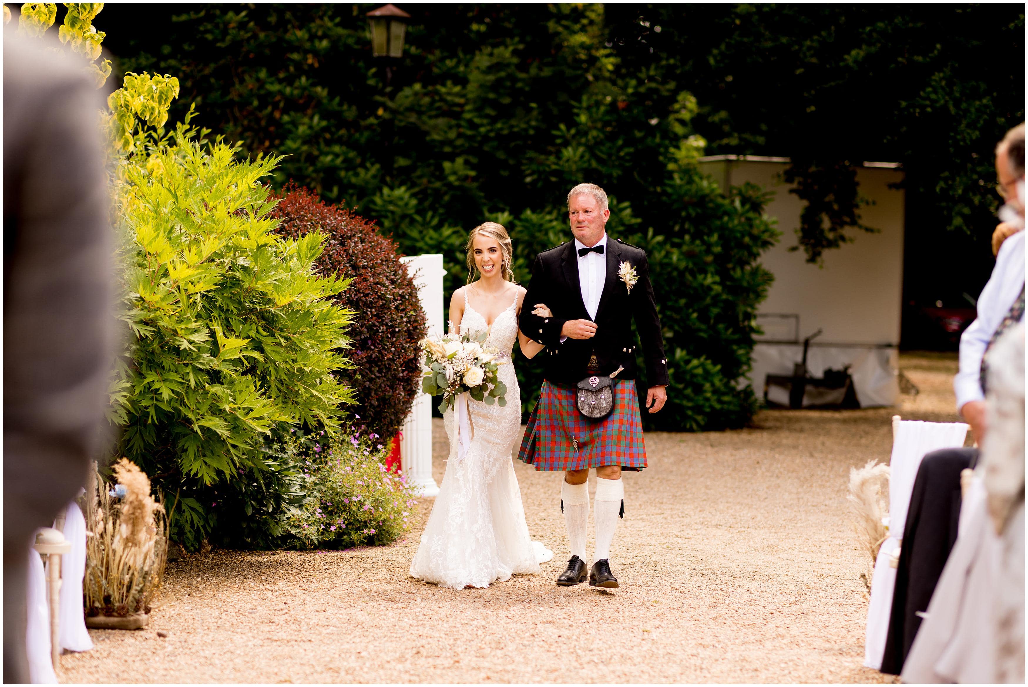 Bride walking down the aisle at Bradgate Manor