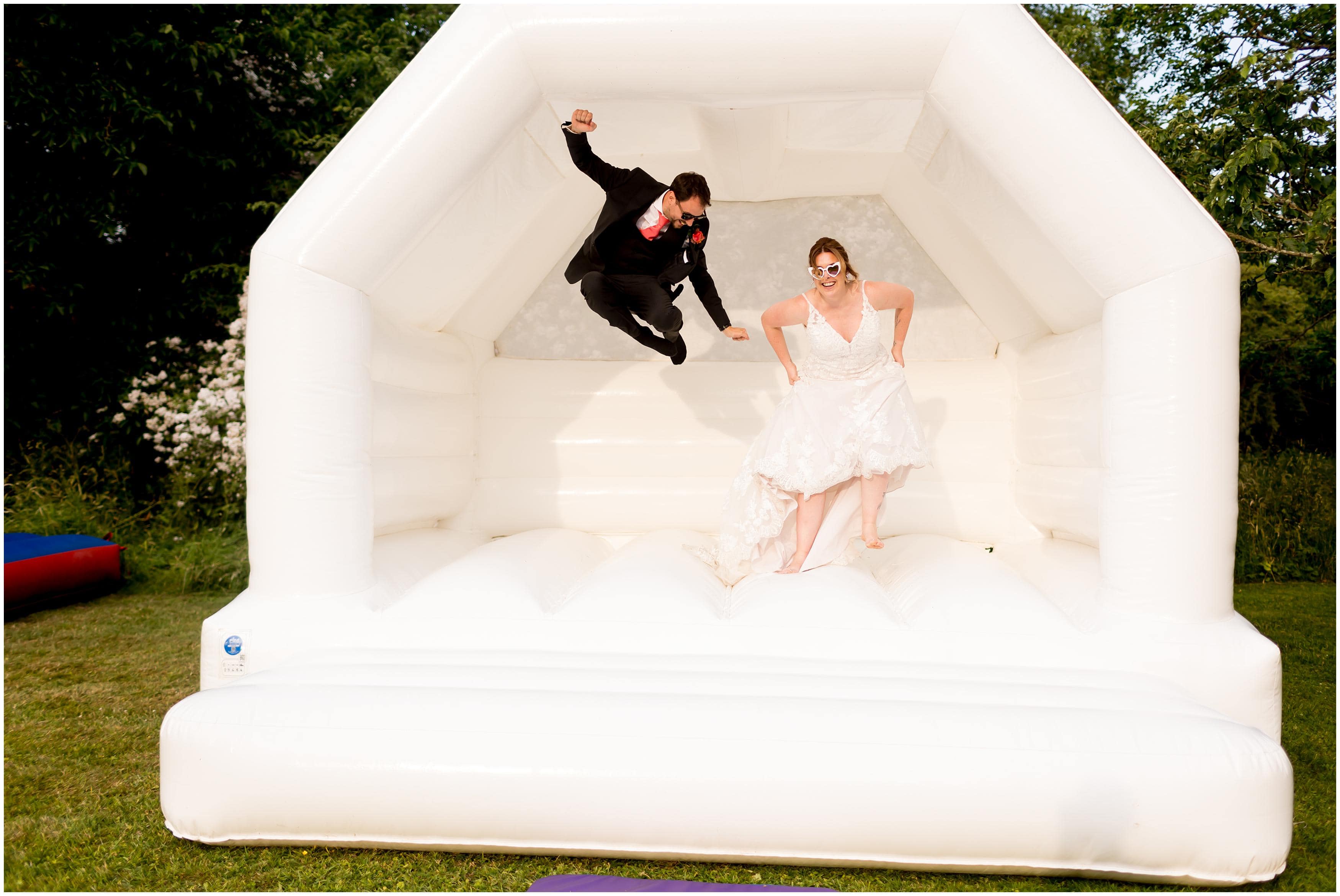 bride and groom on bouncy castle