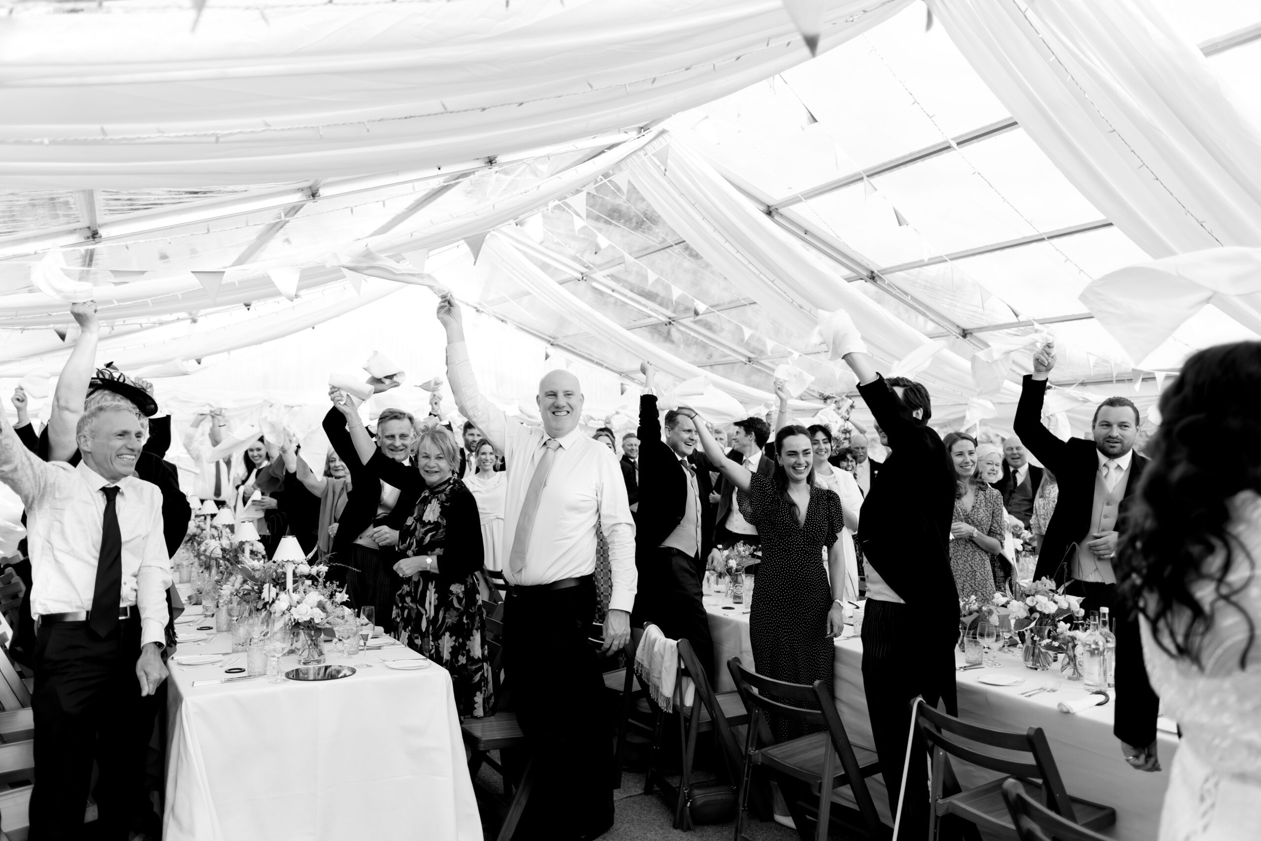 wedding party celebrating with napkins twirling